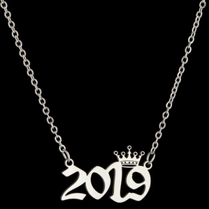 Macro shot of silver stainless steel 2019 number necklace with crown detail