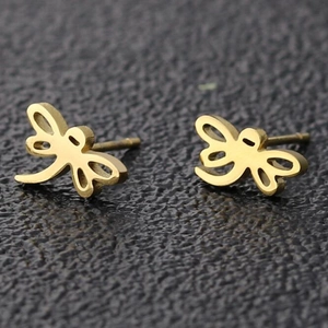 Gold stainless steel dragonfly stud earrings with delicate hollow wings on black background