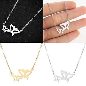 Close-up of butterfly pendant necklace with double hollow charms in gold and silver finish