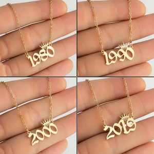 Golden stainless steel crown birth year necklaces featuring years 1980, 1990, 2000, and 2010