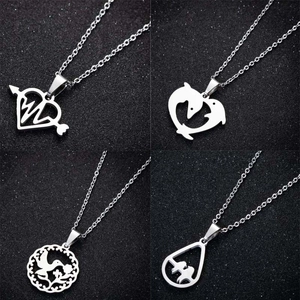 Set of four stainless steel pendant necklaces featuring heart, dolphin, and bird designs