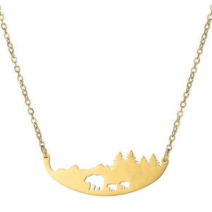 Détail du pendentif doré évidé avec motif famille d'ours dans la forêt de montagne