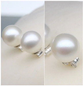 Detail view of round white pearl earrings with S925 sterling silver butterfly backs