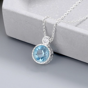 Exquisite Heart of the Ocean round light blue crystal necklace on a geometric stone stand