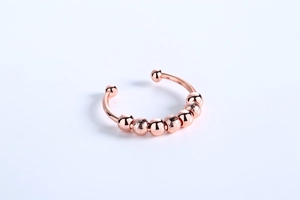 Detail of rose gold spinning anxiety ring with 7 polished and frosted beads