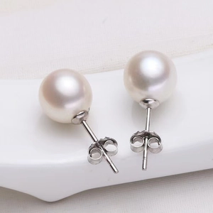 Classic 925 silver stud earrings with 8mm round white pearls on white textured background