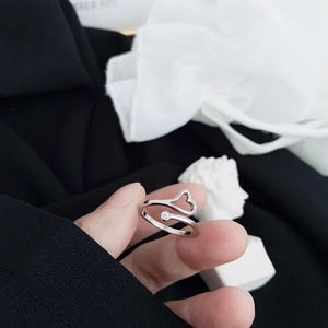 Detail of S925 silver open ring with hollow heart design and a single round zircon stone