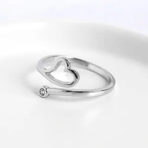 Adjustable silver heart ring with open band and sparkling cubic zirconia accent