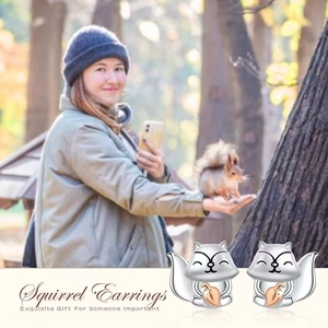 Detailed view of silver squirrel earrings holding a rose gold leaf with S925 silver studs