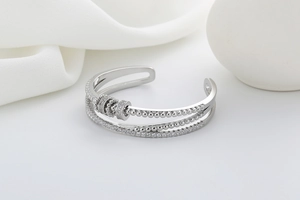 Macro shot of silver multi-layer open bracelet with sparkling cubic zirconia and beads