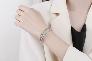 Macro detail of multilayer silver bangle with micro-pave cubic zirconia on model wrist