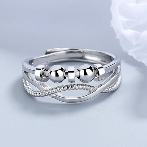 Adjustable silver anti-stress ring featuring rotating beads and a braided rope band design