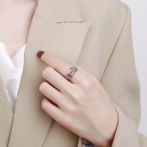 Minimalist double-layered spinning bead ring for anxiety relief on a model in beige suit