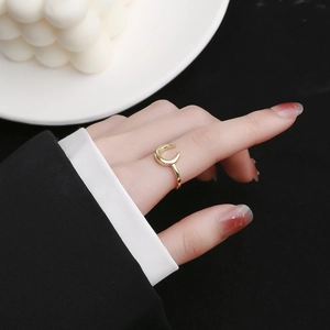 Minimalist gold moon ring with polished U-shape design worn on the index finger