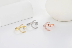Close-up of S925 sterling silver crescent moon and star rings in three elegant plating colors
