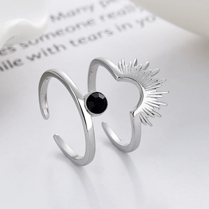Adjustable silver sunburst ring set featuring a round black gemstone in minimalist style