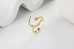 Detail of S925 hallmark on gold crescent moon and star ring with micro-pave zircons
