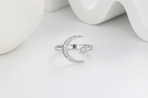Macro detail of crescent moon and star ring with silver finish and sparkling crystals
