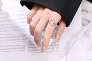Close-up of a silver crescent moon and star open ring with sparkling white zircons