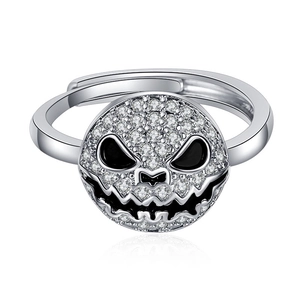 Macro shot of silver ring featuring a diamond-set Halloween pumpkin face with black enamel