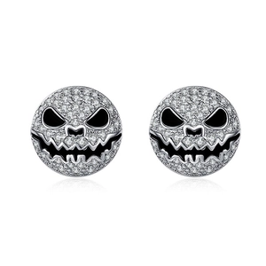 Detail of silver pumpkin smile earrings with white cubic zirconia and black enamel work