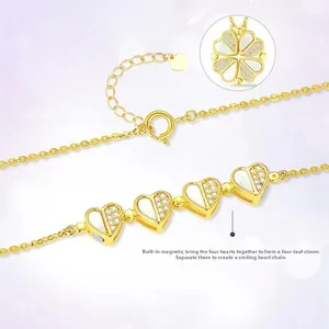 Detail showing magnetic four-leaf clover necklace with white stones in gold finish