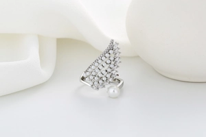 Macro detail of winged open ring featuring micro-pave pearls and zircon on silk