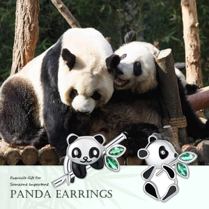 Detailed view of panda studs featuring black enamel details and green gemstone leaves