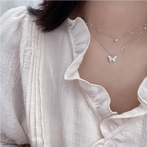 Double layered silver butterfly necklace with sparkling zircon crystals on model