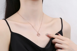 Detailed view of rose gold necklace with hollow Fuxi pendant and micro-set diamonds