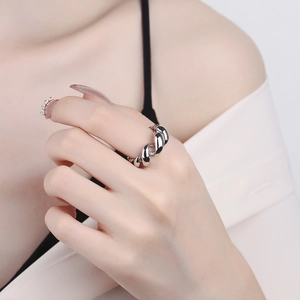 Polished silver twisted croissant dome ring with a shiny metallic mirror finish