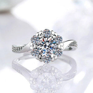 Classic round moissanite ring with six-prong floral setting and twisted pavé band with reflection