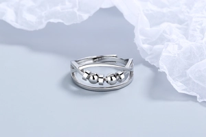 Detail of silver double-layered ring with rotatable beads and adjustable open band