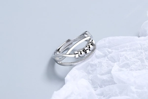 Macro detail of S925 sterling silver ring showing movable beads and interior hallmark