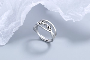Detail of S925 sterling silver ring with two rotating beads on a minimalist open band