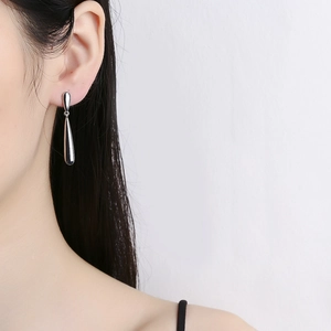 Elegant polished silver teardrop earrings with a minimalist geometric dangle design
