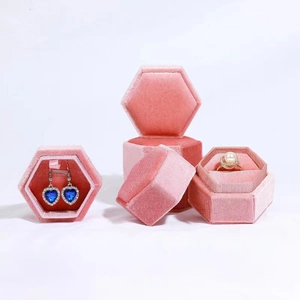 Detailed macro view of pink hexagonal velvet jewelry boxes for rings and earrings