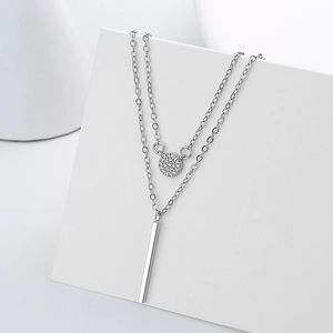 Double layer silver necklace featuring a sparkling zircon round pendant and minimalist bar