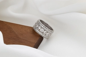 Close-up of a wide vintage copper ring with cubic zirconia micro-pave and milgrain edges