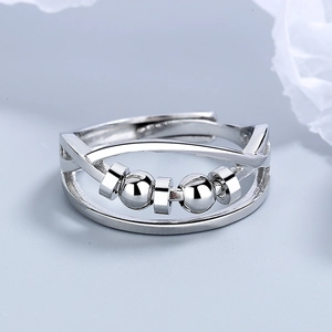Silver fidget ring with double-layered cross design and rotating beads for stress relief