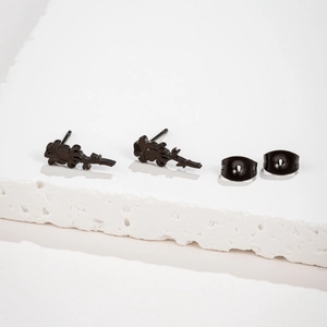 Close-up of matte black rose stud earrings with petal and leaf details on stone base