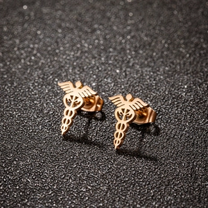 Rose gold stainless steel Caduceus medical symbol stud earrings on black background