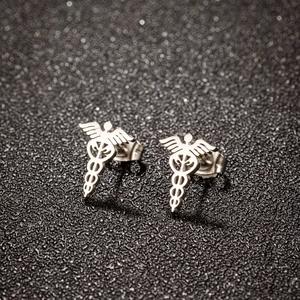 Macro detail of silver medical caduceus stud earrings in polished stainless steel