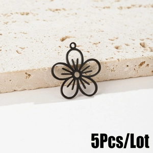 Detail view of black hollow flower charms in a 5-piece lot set for DIY jewelry