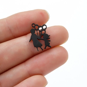 Macro shot of a black matte stainless steel mother and child silhouette pendant charm
