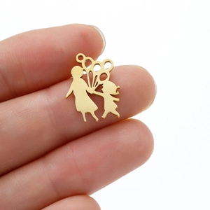 Close-up of golden stainless steel hollow pendant showing two girls holding a balloon