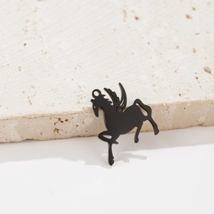 Macro shot of black stainless steel Pegasus pendant with detailed wings on stone