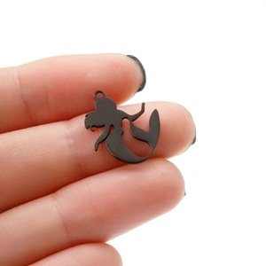 Minimalist black stainless steel mermaid pendant charm held between fingers for scale