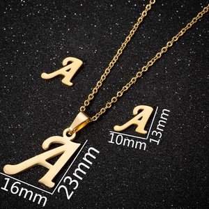 Detailed view of golden letter A necklace and earring set with size dimensions