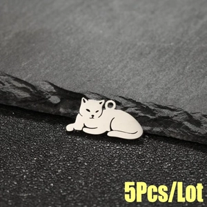 5Pcs stainless steel leopard cat charms with polished finish on a dark stone background